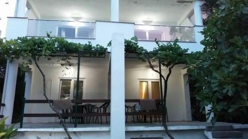 a view of a house with a table and chairs at Apartmani M&E in Tivat