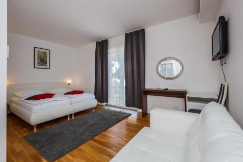 a living room with two beds and a television at Villa Sveti Križ in Trogir