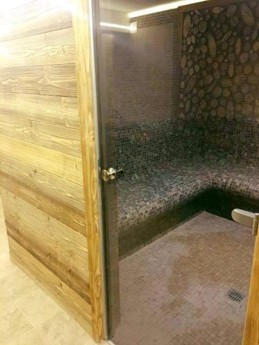 a shower with a glass door in a bathroom at Popasul Domnesc- Resort& Spa- Voronet Vue in Voronet
