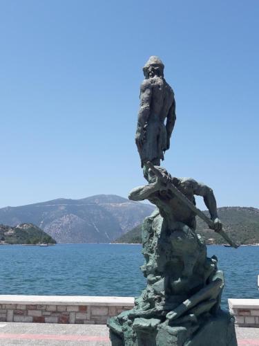 a statue in front of a body of water at Korona Apartments in Vathi, Ithaka