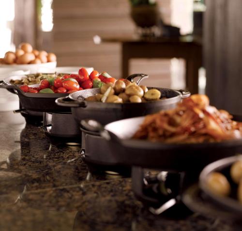 two pans of food on top of a counter at Park Hyatt Busan in Busan