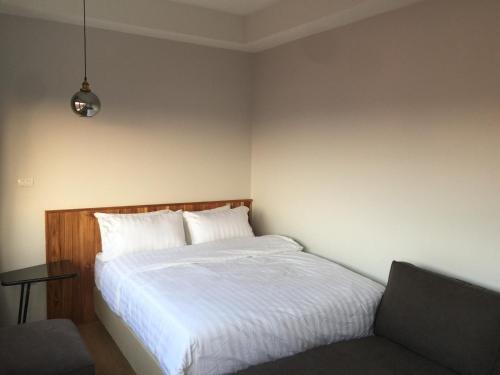 a bedroom with a bed and a chair in it at U Chiangkhan in Chiang Khan