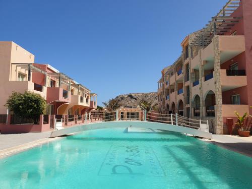 a swimming pool in the middle of a building at Aparthotel Por do Sol in Sal Rei