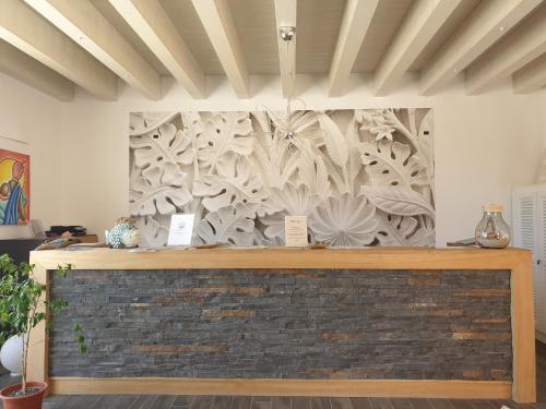 a wall with a mural of flowers on it at Aparthotel Por do Sol in Sal Rei