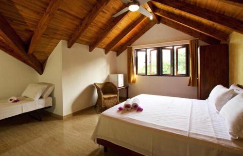 a bedroom with a large bed with flowers on it at Villa Sole in Anse Volbert Village