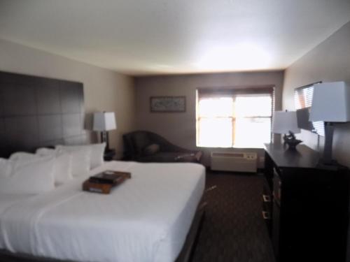 a bedroom with a large white bed and a window at Breck Inn in Breckenridge
