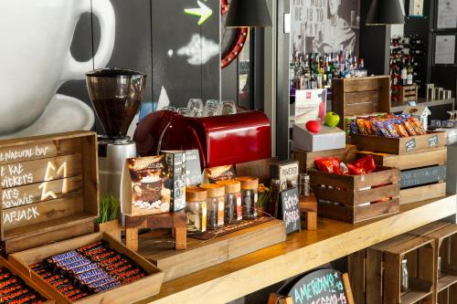 a counter with a coffee maker on top of it at ibis Brighton City Centre - Station in Brighton & Hove