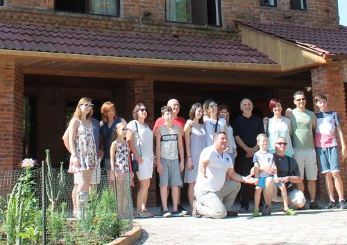 a group of people posing for a picture in front of a building at Chateau Chikovani in Gordi