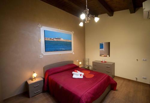 a bedroom with a bed with a stuffed animal on it at Casa Aruci Sweet Home in Scicli