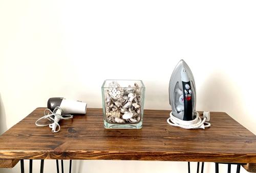 a table with a vase with rocks and a mirror at Home Crowd Luxury Apartments in Doncaster