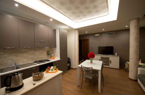 a kitchen with a sink and a table in a room at Casa Aruci Sweet Home in Scicli