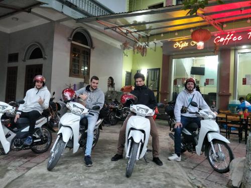 a group of men sitting on motorcycles in front of a building at Ngan Ha Homestay in Ha Giang