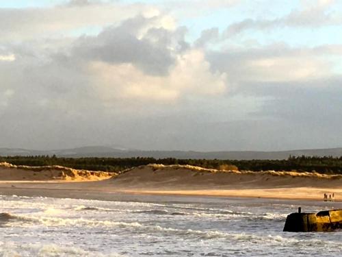 a boat in the water on a beach at 3 Marina Quay in Lossiemouth