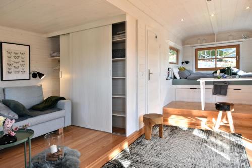 a living room with a couch and a table at Tiny House Dreischwesternherz in Trier