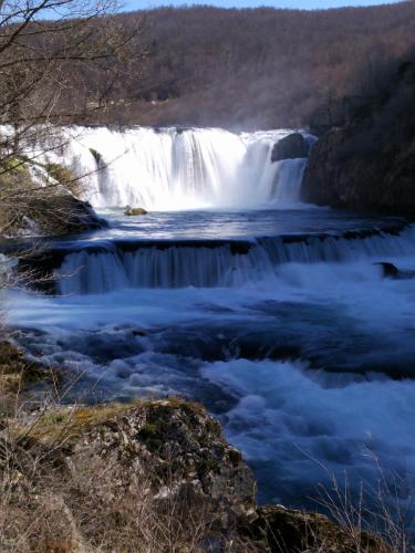 a waterfall in the middle of a river at Seosko domacinstvo Halil & Alema in Ćukovi