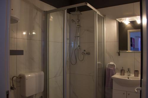 a bathroom with a shower and a sink at BMB Apartments in Senj