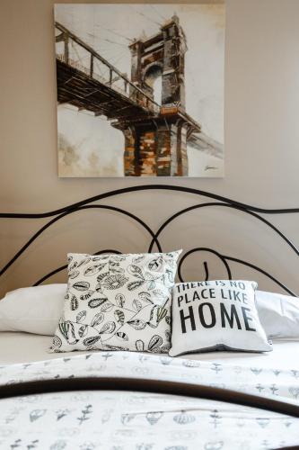 a bed with a pillow with a bridge like home at The Orange Garden in Nafplio