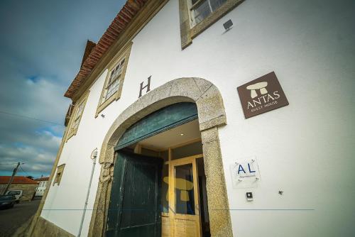 a building with a sign on the side of it at Antas Guest House in Esposende