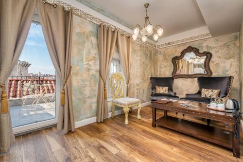 a room with a table and a mirror and a window at Plaza Marchi Old Town - MAG Quaint & Elegant Boutique Hotels in Split