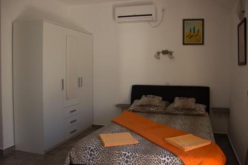 a bedroom with two beds and a dresser in it at BMB Apartments in Senj