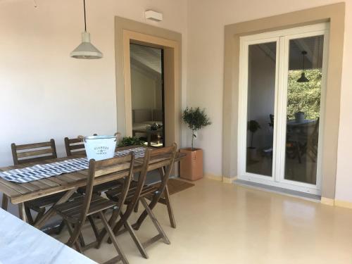 a dining room with a wooden table and chairs at Sirios in Acharavi