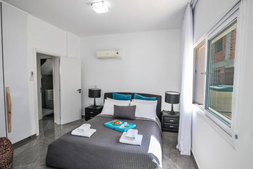 a bedroom with a bed with two towels on it at Marimar villa in Protaras