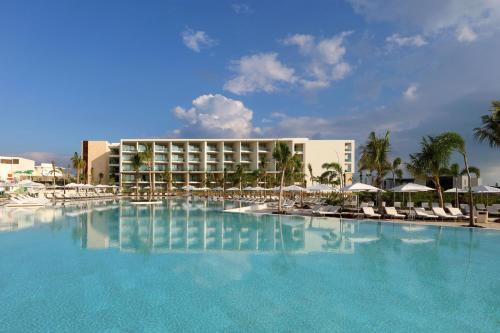 a large swimming pool in front of a hotel at Family Selection at Grand Palladium Costa Mujeres Resort & Spa - All Inclusive in Cancún