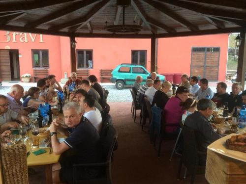 a group of people sitting at tables in a restaurant at Agriturismo Polla in Camporgiano
