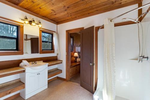 ein Badezimmer mit einem weißen Waschbecken und einer Dusche in der Unterkunft West Beach Resort in Eastsound