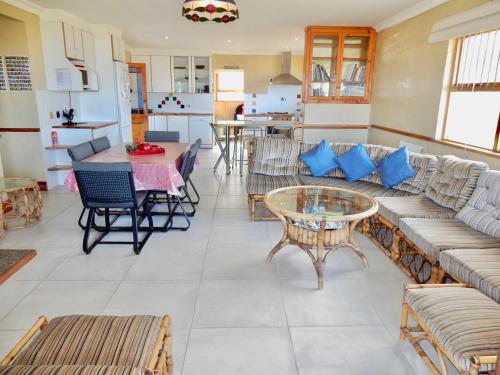 a living room with a couch and a table at Mountain Mist in Bettyʼs Bay