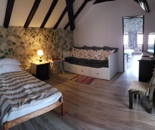 a bedroom with a bed and two tables in a room at Pensiunea Casa Dacilor in Podeni