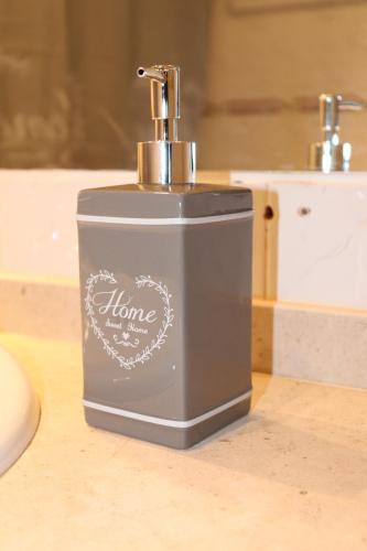 a grey soap dispenser sitting on a counter at Cantinho da Cacilda in Grândola