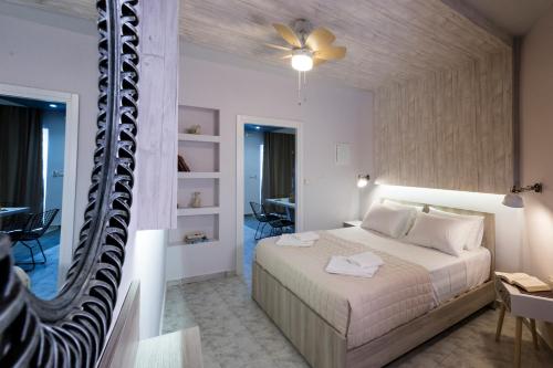 a bedroom with a bed and a mirror at NK Apartments in Falasarna
