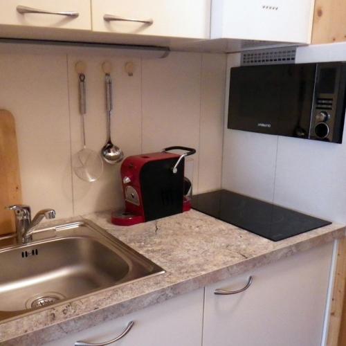 a kitchen with a sink and a toaster on a counter at Ferienwohnung Klein&Fein in Bad Aussee