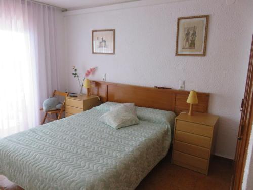 a bedroom with a bed and a table and a lamp at Panorama 29 in Miami Platja