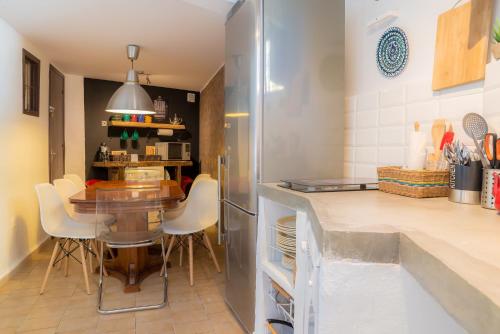 a kitchen with a table and a dining room at BENDITA CASA in Granada