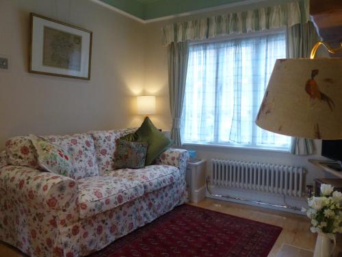 a living room with a couch and a window at The Little House in Devizes