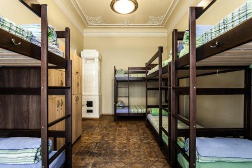a room with several bunk beds in a building at Leosphere Hostel in Lviv