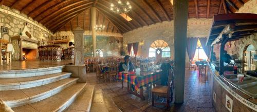 a man sitting at a table in a restaurant at Hotel Mansion Tarahumara in Areponapuchi