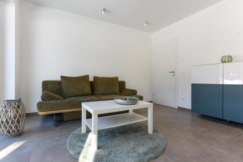 a living room with a couch and a table at Seechalet in Altossiach