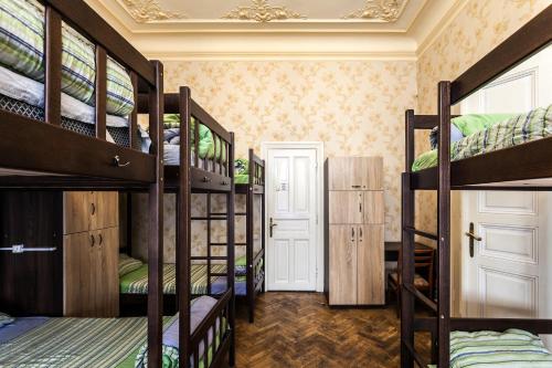 a room with a bunch of bunk beds at Leosphere Hostel in Lviv
