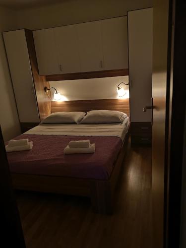 a bedroom with a bed with two towels on it at Holiday Home Cvitka in Vis