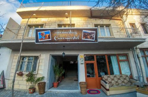 a building with a sign for aconservatoryconservatories at Homestay Cave Hostel in Goreme