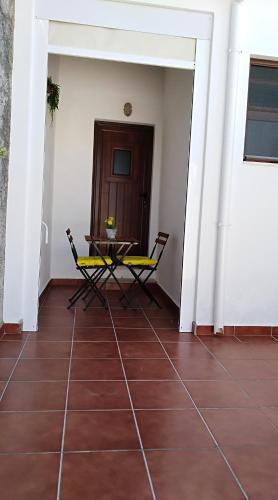 a room with a table and chairs on a tiled floor at Casa BENVINDHA in Degolados