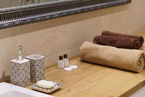 a bathroom counter with a sink and a mirror at Apartament z tarasem in Kielce