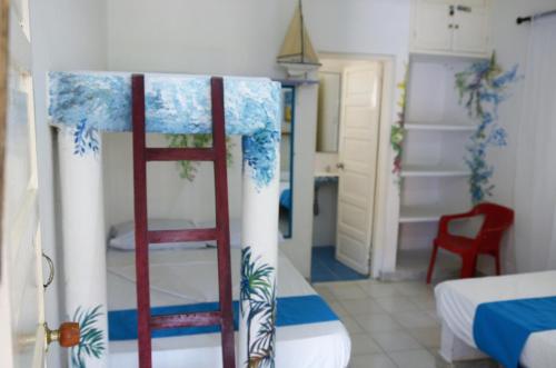Ένα ή περισσότερα κρεβάτια σε δωμάτιο στο Cabañas Los Juanchos Coveñas