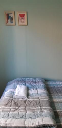 a bed in a room with a white wall at Birdsnest Hostel Hongdae Foreigner only in Seoul