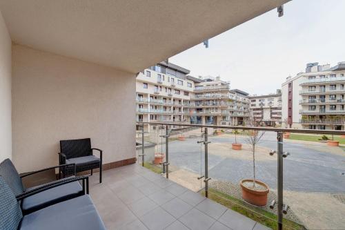 a balcony with a view of a courtyard with buildings at Ludwinowska11 Apartments in Kraków