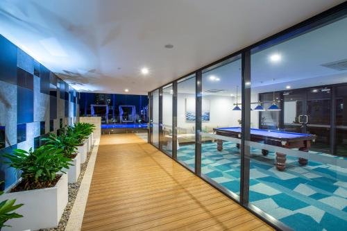 a room with a ping pong table in the middle at Qube Broadbeach in Gold Coast