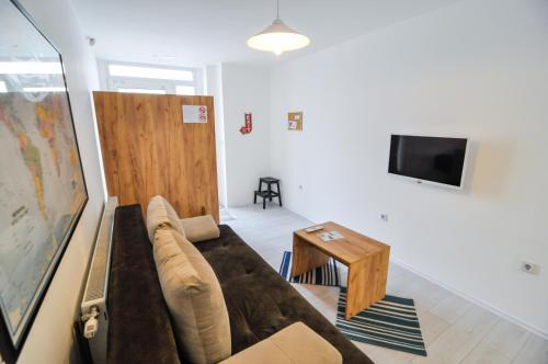 a living room with a couch and a table at Torus Apartments in Sarajevo